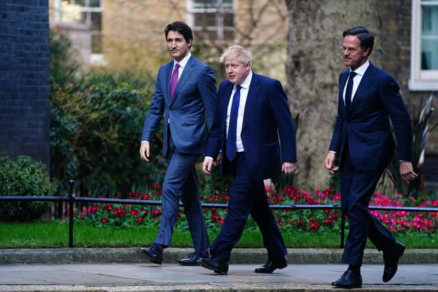Prime Minister Boris Johnson (centre) arrives in Downing Street, London, with the Canadian Prime Minister Justin Trudeau (left) and the Dutch Prime Minister Mark Rutte (right)