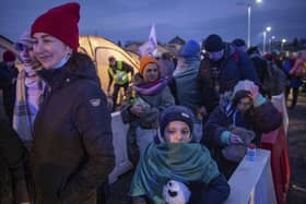 Women and children wait to board a bus heading for Przemysl, after fleeing from Ukraine, at the border crossing in Medyka, Poland, Wednesday, March 9, 2022. U.N. officials said that the Russian onslaught has forced 2 million people to flee Ukraine. It has trapped others inside besieged cities that are running low on food, water and medicine amid the biggest ground war in Europe since World War II. (AP Photo/Visar Kryeziu).