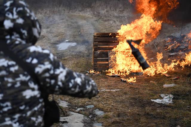 A man throws a cocktail Molotovs during a self-defence civilian course on the outskirts of Lviv, western Ukraine, on March 4, 2022. - The Russian army occupied on March 4, 2022 the Ukrainian nuclear power plant of Zaporozhie (south), the largest in Europe, where bombings in the night have raised fears of a disaster as more than 1.2 million people have fled Ukraine into neighbouring countries since Russia launched its full-scale invasion on February 24, United Nations figures showed on March 4, 2022. (Photo by Daniel LEAL / AFP) (Photo by DANIEL LEAL/AFP via Getty Images),