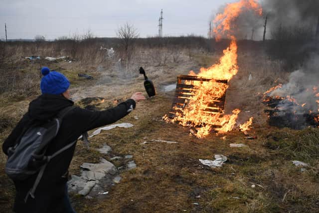 A man throws a cocktail Molotovs during a self-defence civilian course on the outskirts of Lviv, western Ukraine, on March 4, 2022. - The Russian army occupied on March 4, 2022 the Ukrainian nuclear power plant of Zaporozhie (south), the largest in Europe, where bombings in the night have raised fears of a disaster as more than 1.2 million people have fled Ukraine into neighbouring countries since Russia launched its full-scale invasion on February 24, United Nations figures showed on March 4, 2022. (Photo by Daniel LEAL / AFP) (Photo by DANIEL LEAL/AFP via Getty Images).