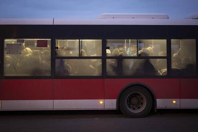 Women and children board a bus heading for Przemysl, after fleeing from Ukraine, at the border crossing in Medyka, Poland, Wednesday, March 9, 2022. U.N. officials said that the Russian onslaught has forced 2 million people to flee Ukraine. It has trapped others inside besieged cities that are running low on food, water and medicine amid the biggest ground war in Europe since World War II. (AP Photo/Visar Kryeziu).