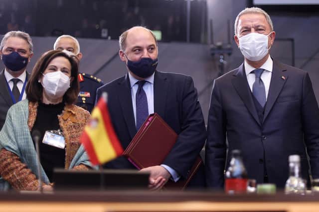 (L to R) Spanish Defence Minister Margarita Robles, Britain's Secretary of State for Defence Ben Wallace and Turkish Defence Minister Hulusi Akar pose at the start of a NATO Defence ministers meeting at NATO headquarters in Brussels, on February 16, 2022. (Photo by Kenzo TRIBOUILLARD / AFP).