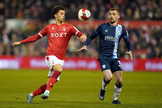 Nottingham Forest's Brennan Johnson battles with Huddersfield Town's Harry Toffolo during the Emirates FA Cup fifth round match at the City Ground (Picture: Nick Potts/PA Wire)