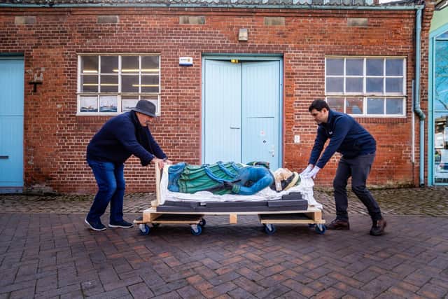 Volunteer Jozef Jurkiewicz, a fomer fisherman, and Stathis Tsolis, Conservation & Engagement Officer for Hull Maritime Museum, moving a wooden figurehead - kknown as Lady In Blue  Picture: James Hardisty
