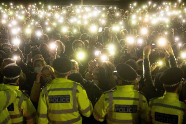 Photo dated 13/03/21 of people in the crowd turning on their phone torches in Clapham Common, London, for a vigil for Sarah Everard.