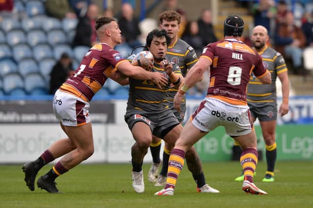 Tigers' Mahe Fonua is tackled by Owen Trout, as Chris Hill watches on. Picture by Bruce Rollinson.