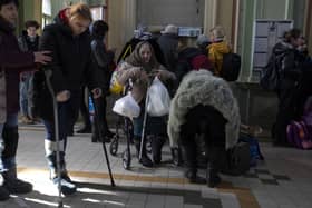 Refugees who fled the war from Ukraine arrive at the Przemysl train station, southeastern Poland, on Saturday, March 12, 2022. Russian troops are pressing their offensive across Ukraine, pounding populated areas with artillery and airstrikes and deploying siege tactics honed in Syria and Chechnya where opposing cities were reduced to rubble. (AP Photo/Petros Giannakouris).