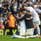 Leeds United's Rodrigo, Raphinha and Jack Harrison embrace at the final whistle. Pictures: Tony Johnson
