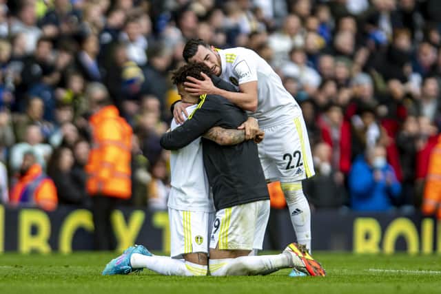 Leeds United's Rodrigo, Raphinha and Jack Harrison embrace at the final whistle. Pictures: Tony Johnson