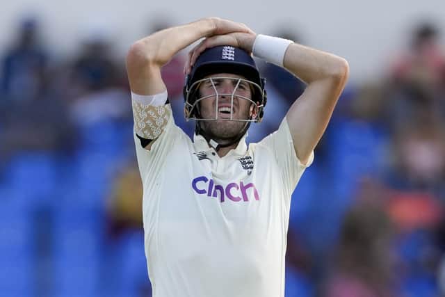 England's Zak Crawley hold his head during the third session of day five of the first cricket Test match against West Indies at the Sir Vivian Richards Cricket Ground in North Sound, Antigua and Barbuda, Saturday, March 12, 2022. (AP Photo/Ricardo Mazalan)