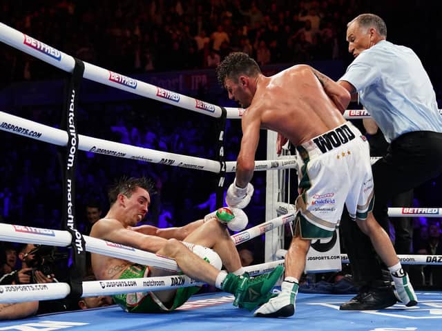 Michael Conlan falls out of the ring after being knocked out by Leigh Wood in their WBA Featherweight World Title contest at the Motorpoint Arena, Nottingham. (Picture: Zac Goodwin/PA Wire)