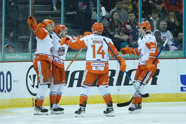 WINNING STRIKE: Sheffield Steelers' Tanner Eberle (second left) celebrates scoring what proved to be the game-winning goal against Belfast Giants at the SSE Arena on Saturday night. Picture: Darren Kidd/Presseye/EIHL