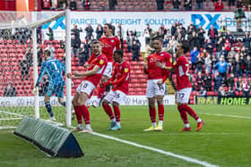 OPENING SALVO: Carlton Morris celebrates with his team-mates after scoring from the penalty spot for Barnsley against Fulham at Oakwell on Saturday. Picture: Tony Johnson.