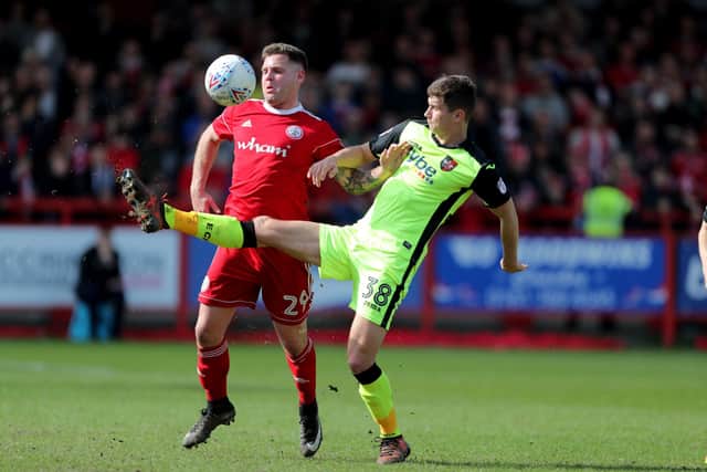 Exeter City's Jordan Storey in action for Exeter City, battling with Accrington Stanley's Billy Kee in April 2018 Picture: Richard Sellers/PA