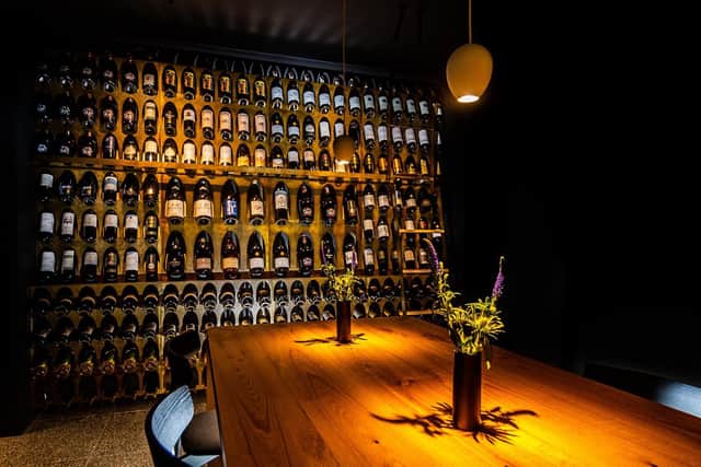 Second dining room with a wine mounted wall wine rack which contains 228 normal bottle of wine and 16 magnum wine bottles
