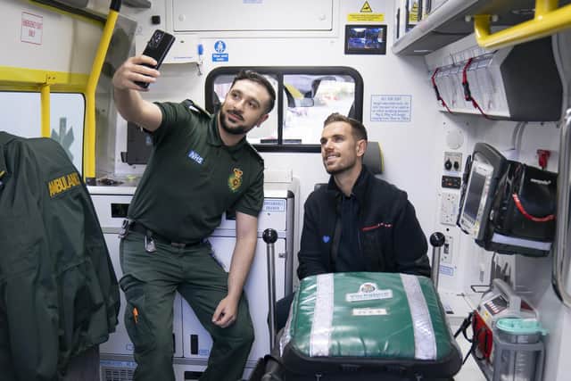 England star and Liverpool captain Jordan Henderson (right) has a selfie taken with Clinical Team Leader Zain Kazmi (left), in the back of an ambulance