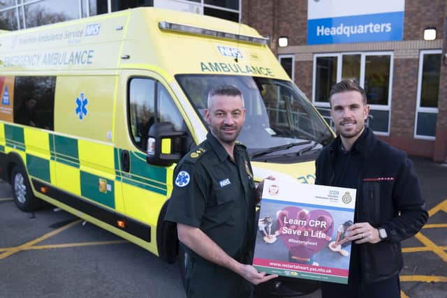 England star and Liverpool captain Jordan Henderson (right) and Andy Pippin, Head of Operations at Yorkshire Ambulance Service, hold an NHS 'Learn CPR save a life' sign