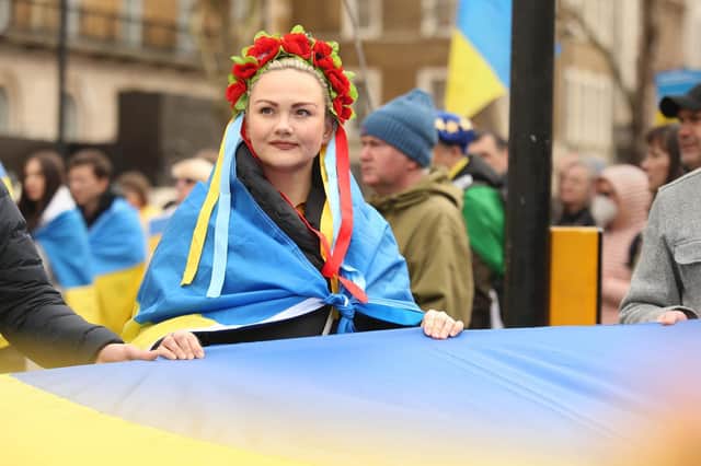 People hold a flag during a demonstration organised by London EuroMaidan and British-Ukrainian volunteers outside Downing Street, London