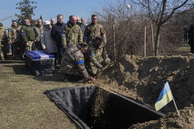 Ukrainian soldiers pay the last tribute to colonel Valeriy Gudz who was killed in a battle against the Russian invaders in a cemetery in the town of Boryspil close to capital Kyiv, Ukraine, Tuesday, March 15, 2022. (AP Photo/Efrem Lukatsky).