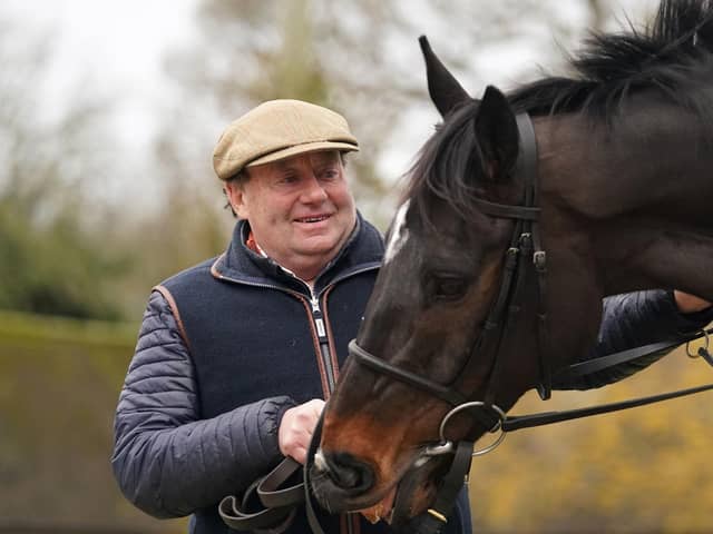 Nicky Henderson and Shishkin during the visit to Nicky Henderson's yard at Seven Barrows in Lambourn, Berkshire, ahead of the Queen Mother Champion Chase.