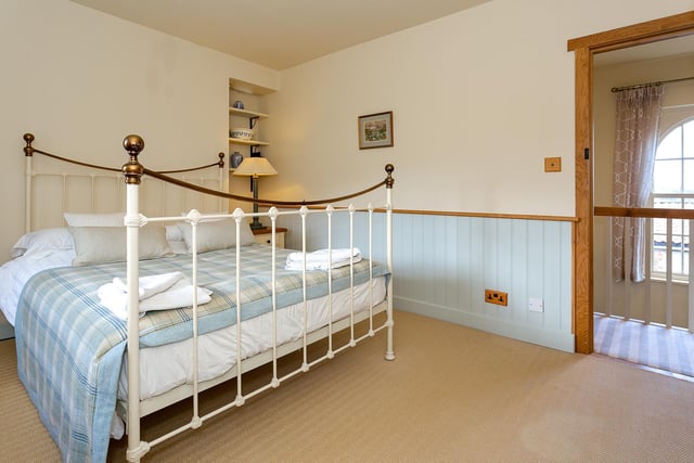 One of the bedrooms with a Victorian style bedframe