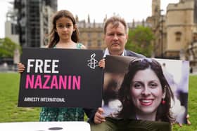 File photo dated 23/09/21 of Richard Ratcliffe and his daughter Gabriella holding signs in Parliament Square, London, to mark the 2,000th day Nazanin Zaghari-Ratcliffe had been detained in Iran.