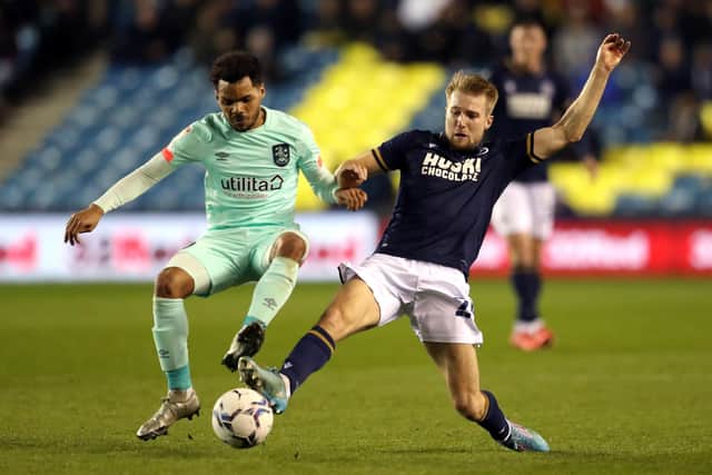 Huddersfield Town's Duane Holmes (left) and Millwall's Billy Mitchell battle for the ball.