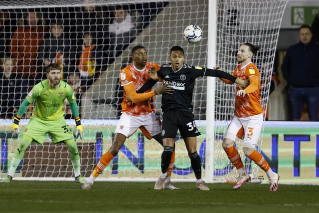 Held up: Sheffield United’s Kyron Gordon, centre, is surrounded by Blackpool’s Marvin Ekpiteta, left, and James Husband. (Picture: Richard Sellers/PA)
