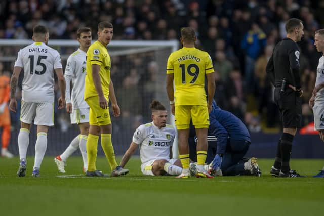 THE LAST TIME: Leeds United's Kalvin Phillips recieves treatment on the pitch at Elland Road in the Premier League clasj against Brentford - the last time he played for the Whites. 
Picture: Tony Johnson