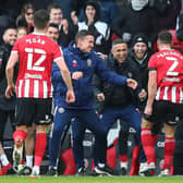 RARE TREAT: Sheffield United manager Paul Heckingbottom and coach Jack lester celebrate with George Baldock after his goal against Swansea City