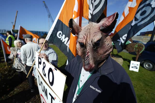 Protesters stand outside the P&O building at the Port of Hull, East Yorkshire, after P&O Ferries suspended sailings and handed 800 seafarers immediate severance notices.