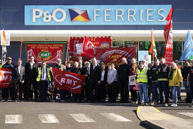 Protesters stand outside the P&O building at the Port of Hull, East Yorkshire, after P&O Ferries suspended sailings and handed 800 seafarers immediate severance notices.