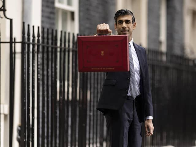Chancellor Rishi Sunak holds the Budget box as he departs 11, Downing Street, ahead of delivering his Autumn Budget and Spending Review to Parliament on October 27, 2021.  He has been warned by economists that the cost of living crisis is set to compound long-running regional economic inequalities. (Photo by Dan Kitwood/Getty Images)
