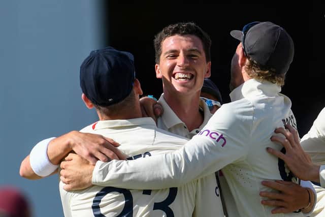 Matthew Fisher (C) of England celebrates his first test wicket, the dismissal of John Campbell of West Indies. (Photo by RANDY BROOKS/AFP via Getty Images)
