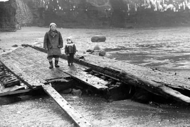 Man and child on a keel wreck. Pictures by John Tindale, courtesy of the Whitby Museum.