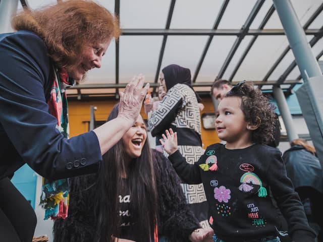 Welsh Government deputy minister for social services Julie Morgan high-fives a child in celebration of the new law banning the physical punishment of children. Welsh Government/PA Wire