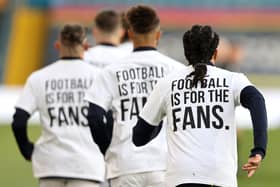 Leeds United players wearing 'Football Is For The Fans' shirts during the warm up prior to kick-off during the Premier League match at Elland Road against Liverpool last season (Picture: PA)