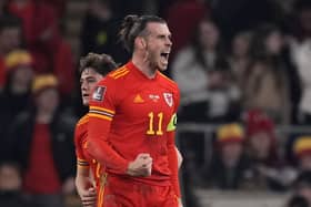 Wales' Gareth Bale celebrates after scoring the opening goal of his team during the World Cup 2022 playoff soccer match between Wales and Austria at Cardiff City stadium. (AP Photo/Matt Dunham)