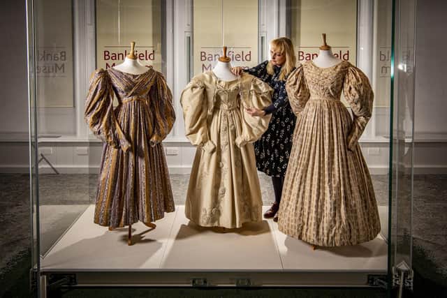 Curator Elinor Camille-Wood with a wedding dress worn by a Scots woman for her marriage to a Bradford mill owner, loaned by Bradford museums on display for Fashion in Anne Lister's Time (1791-1840) at the Bankfield Museum in Halifax.