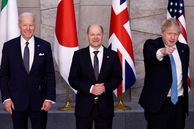 U.S. President Joe Biden, Germany's Chancellor Olaf Scholz and Prime Minister Boris Johnson, pose for a G7 leaders' family photo during a Nato summit in Brussels, Belgium to discuss Russia's invasion of Ukraine.
