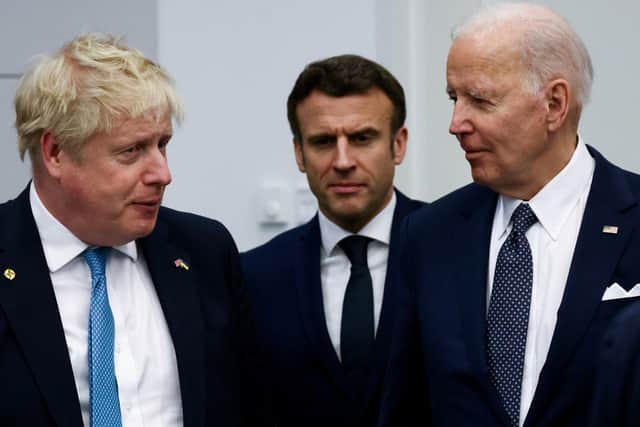 Prime Minister Boris Johnson, France's President Emmanuel Macron and U.S. President Joe Biden arrive for a G7 leaders meeting during a NATO summit on Russia's invasion of Ukraine, at the alliance's headquarters in Brussels, Belgium.
