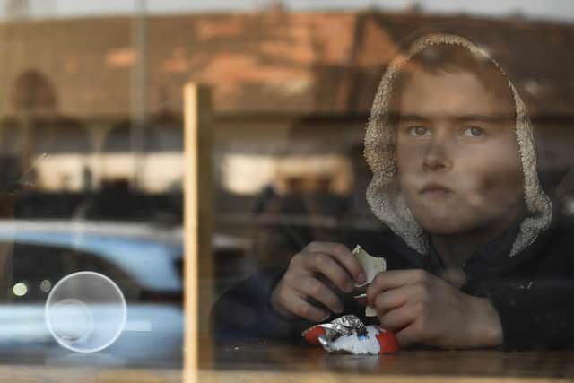 A young boy from Ukraine eats chocolate in a hostel in Budapest, Hungary, Thursday, March 24, 2022. Nearly 300 Ukrainian refugees, mostly women and children, are being housed in a hostel outside the city centre of Hungary's capital of Budapest.  (AP Photo/Anna Szilagyi)