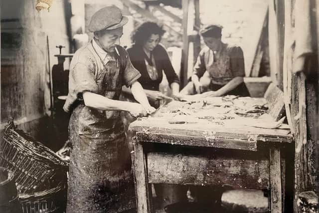 An old photograph shows workers at Fortune's preparing herring for smoking at Fortune's Kippers in Whitby.