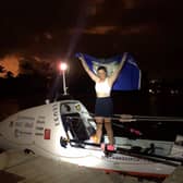 Tori Evans holding the Yorkshire flag aloft after rowing 2,559 nautical miles in 40 days and 19 hours to complete the fastest ever female solo row across the Atlantic Credit: Sea Change Sport