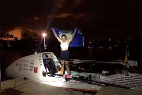 Tori Evans holding the Yorkshire flag aloft after rowing 2,559 nautical miles in 40 days and 19 hours to complete the fastest ever female solo row across the Atlantic Credit: Sea Change Sport