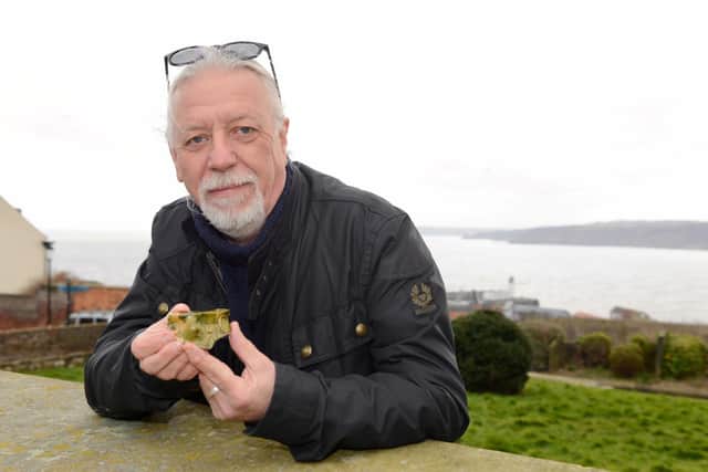 Archeologist John Oxley with a fragment of Scarborough Ware, found at one of last year's miniature digs. Image by Kane Cunningham.
