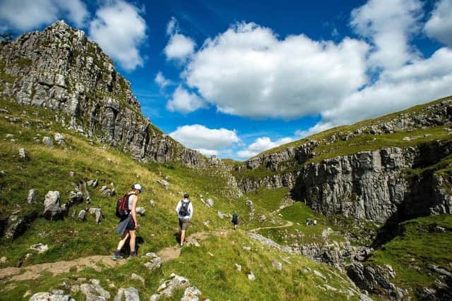 Walkers enjoy the limestone landscape of the dry valley above Malham Cove, which has been one of the most popular destinations in the Yorkshire Dales National Park this year. (Photo: Bruce Rollinson)