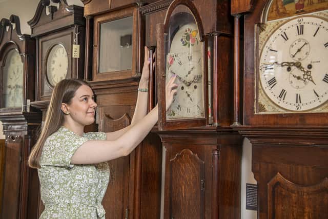 Charlotte Craig changes the clocks at Skipton Museum.