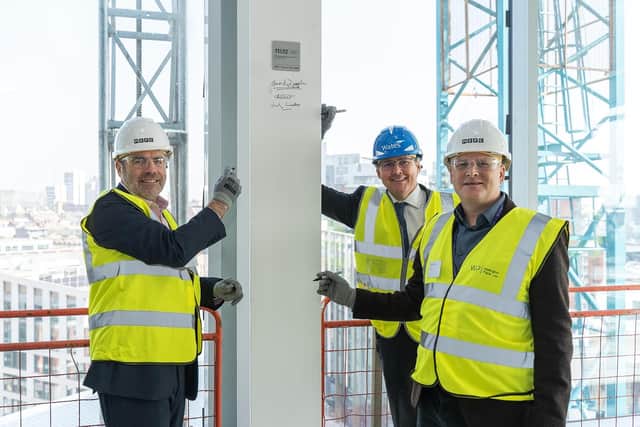 James Dipple, chief executive of MEPC, Andy Wates, director at Wates Construction, and Paul Pavia, commercial director at MEPC, signing the final steel beam at 11 & 12 Wellington Place in Leeds.