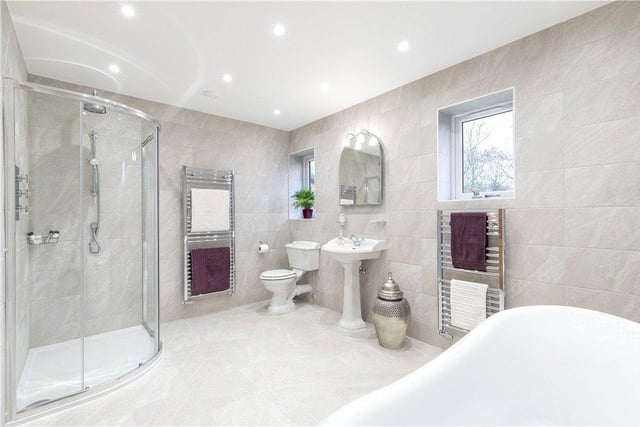 One of the spacious and luxurioys bathrooms with shower and free-standing bath.